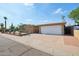Home exterior showcasing a spacious driveway and a large two-car garage for convenience and ample parking at 19615 N 18Th Dr, Phoenix, AZ 85027