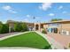 Charming home featuring a well-manicured lawn and inviting entryway, perfect for a welcoming atmosphere at 19615 N 18Th Dr, Phoenix, AZ 85027
