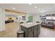 Spacious kitchen island featuring granite countertops and views of the living area and backyard at 19615 N 18Th Dr, Phoenix, AZ 85027