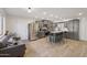 Modern kitchen with gray cabinetry, stainless steel appliances, and an island with barstool seating at 19615 N 18Th Dr, Phoenix, AZ 85027