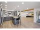 Open-concept kitchen with granite countertops, gray cabinets, and seamless flow into the living room at 19615 N 18Th Dr, Phoenix, AZ 85027