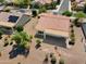 Aerial shot of a home with desert landscaping, a tile roof and solar panels, and a covered back patio at 21532 N 262Nd Ln, Buckeye, AZ 85396