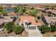 Aerial view of house, desert landscaping, a tile roof with solar panels, and a three-car garage at 21532 N 262Nd Ln, Buckeye, AZ 85396