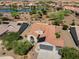 Aerial shot of house, desert landscaping, a tile roof with solar panels, and a three-car garage at 21532 N 262Nd Ln, Buckeye, AZ 85396