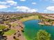 Aerial community view features a large lake, desert landscaping and a golf course at 21532 N 262Nd Ln, Buckeye, AZ 85396