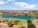 Aerial view of community featuring a large lake, golf course, desert landscaping and multiple homes at 21532 N 262Nd Ln, Buckeye, AZ 85396