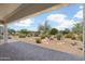 Beautiful covered patio area with serene desert landscaping, creating a tranquil outdoor space at 21532 N 262Nd Ln, Buckeye, AZ 85396