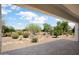 Relaxing covered patio with desert landscaping and views of the surrounding desert community at 21532 N 262Nd Ln, Buckeye, AZ 85396
