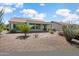 Back of the house with desert landscaping, featuring a covered patio and views of a community at 21532 N 262Nd Ln, Buckeye, AZ 85396