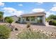 Backyard features desert landscaping, a covered patio, and views of a community on a sunny day at 21532 N 262Nd Ln, Buckeye, AZ 85396