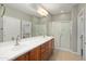Bathroom featuring double vanity, shower with glass door and neutral color pallette at 21532 N 262Nd Ln, Buckeye, AZ 85396