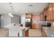 Spacious kitchen with stainless appliances and breakfast bar adjacent to seating area at 21532 N 262Nd Ln, Buckeye, AZ 85396