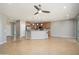 Open-concept living room featuring tile flooring, a kitchen island, and stainless steel appliances at 21532 N 262Nd Ln, Buckeye, AZ 85396