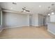 Large living room with tile floors, neutral paint, and recessed lighting throughout the open-concept design at 21532 N 262Nd Ln, Buckeye, AZ 85396