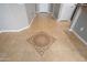 Close-up of the tile flooring, showcasing a decorative medallion inset in the home's foyer at 21532 N 262Nd Ln, Buckeye, AZ 85396