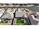 Aerial view showcases a home's roof, backyard with artificial turf, hardscape, and a pergola, adding style to the property at 2518 E Novak Way, Phoenix, AZ 85042