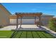 Backyard patio featuring a custom pergola with an outdoor kitchen and new synthetic grass at 2518 E Novak Way, Phoenix, AZ 85042