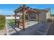 Backyard patio featuring a custom pergola with an outdoor kitchen and new synthetic grass at 2518 E Novak Way, Phoenix, AZ 85042