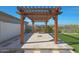 Backyard patio featuring a custom pergola with an outdoor kitchen and new synthetic grass at 2518 E Novak Way, Phoenix, AZ 85042