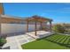 Backyard patio featuring a custom pergola with an outdoor kitchen and new synthetic grass at 2518 E Novak Way, Phoenix, AZ 85042