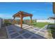 Backyard patio featuring a custom pergola with an outdoor kitchen and new synthetic grass at 2518 E Novak Way, Phoenix, AZ 85042