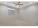 Bright bedroom features a ceiling fan and plush carpet, offering comfort and style at 2518 E Novak Way, Phoenix, AZ 85042