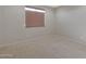 Cozy bedroom features a neutral color palette and a stylish window shade, creating a peaceful retreat at 2518 E Novak Way, Phoenix, AZ 85042