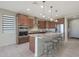 Bright kitchen features a large island with bar seating, stainless appliances, and stylish pendant lighting at 2518 E Novak Way, Phoenix, AZ 85042
