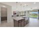 Open-concept kitchen with a large island adjoins the living area with sliding glass doors to the backyard at 2518 E Novak Way, Phoenix, AZ 85042