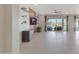 Open-concept living room with large windows, tile flooring, and a unique accent wall at 2518 E Novak Way, Phoenix, AZ 85042