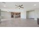 Open-concept living room and kitchen with sleek tile floors and modern lighting fixtures at 2518 E Novak Way, Phoenix, AZ 85042