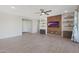 Spacious living room featuring tile flooring, recessed lighting, and a stylish entertainment center at 2518 E Novak Way, Phoenix, AZ 85042