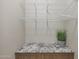 Pantry features wooden cabinets, granite counters, and plenty of white wire shelving for ample storage at 2518 E Novak Way, Phoenix, AZ 85042