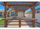Close up of the backyard custom pergola showing the outdoor kitchen and string lights at 2518 E Novak Way, Phoenix, AZ 85042