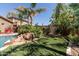 Backyard with artificial turf, mature landscaping, and a tranquil ambiance, perfect for relaxing in your private outdoor space at 27421 N 22Nd Ln, Phoenix, AZ 85085