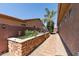 Private backyard featuring raised garden beds and a brick pathway leading to the home at 27421 N 22Nd Ln, Phoenix, AZ 85085