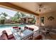 Relaxing backyard setting featuring a covered patio with a pool and a cabana with a fireplace at 27421 N 22Nd Ln, Phoenix, AZ 85085