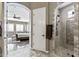 Bathroom featuring a walk-in shower with shower system and access to the main bedroom at 27421 N 22Nd Ln, Phoenix, AZ 85085