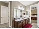 Bathroom boasts double sinks, granite countertop, and an open doorway to the bedroom at 27421 N 22Nd Ln, Phoenix, AZ 85085