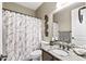 Bathroom has a single sink vanity, and a shower and tub with patterned curtain at 27421 N 22Nd Ln, Phoenix, AZ 85085
