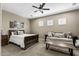 Bedroom boasts a wooden bed frame, an unique sofa, and a coffee table; ceiling fan included at 27421 N 22Nd Ln, Phoenix, AZ 85085