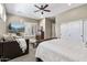 Bedroom boasts a wooden bed frame, an unique sofa, and a TV; includes closet, neutral color scheme at 27421 N 22Nd Ln, Phoenix, AZ 85085