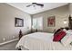 Cozy bedroom featuring neutral walls, carpet, and a wood and iron bed frame with light streaming through the window at 27421 N 22Nd Ln, Phoenix, AZ 85085