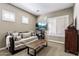 Bedroom features a unique sofa and a TV, shutters on the window, and neutral color scheme at 27421 N 22Nd Ln, Phoenix, AZ 85085