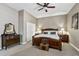 Bedroom featuring a wooden bed frame, dark wooden dresser, two end tables, and neutral carpet at 27421 N 22Nd Ln, Phoenix, AZ 85085