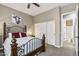 Bedroom featuring neutral walls, carpet, and a wood and iron bed frame with an en suite bathroom at 27421 N 22Nd Ln, Phoenix, AZ 85085