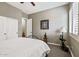 Bedroom featuring neutral walls, carpet, and a wood and iron bed frame with a double door closet at 27421 N 22Nd Ln, Phoenix, AZ 85085