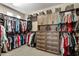 Spacious walk-in closet with custom shelving, drawers, and ample storage space at 27421 N 22Nd Ln, Phoenix, AZ 85085