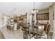 Open concept kitchen and dining area with stainless steel appliances and pendant lighting at 27421 N 22Nd Ln, Phoenix, AZ 85085