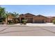 Charming home featuring a three-car garage, desert landscaping, and a stone-accented entry at 27421 N 22Nd Ln, Phoenix, AZ 85085